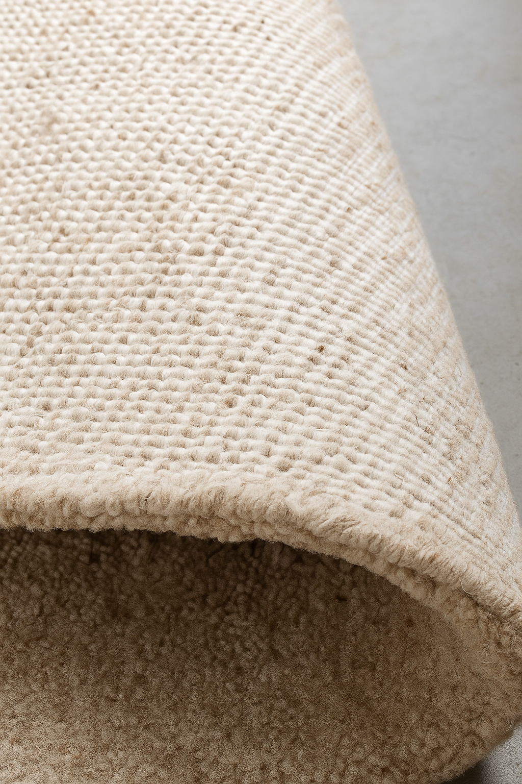 Close-up of a textured beige carpet corner. laine 100% naturelle tapis fais a la main naturug hand made rug morocco maroc marocain