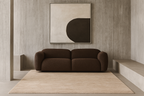 Brown sofa in a room with a abstract painting on the wall laine 100% naturelle fais a la main naturug hand made morocco maroc marocain